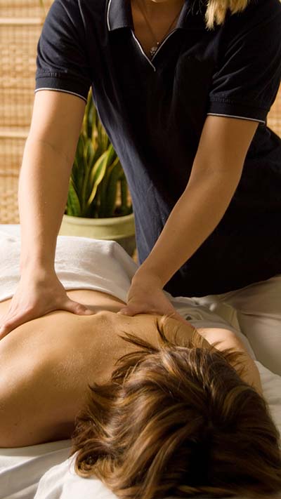 Therapist providing a professional massage at 12th Avenue Massage Therapy Group in Pensacola, offering our core services: structural, therapeutic, and relaxation treatments.